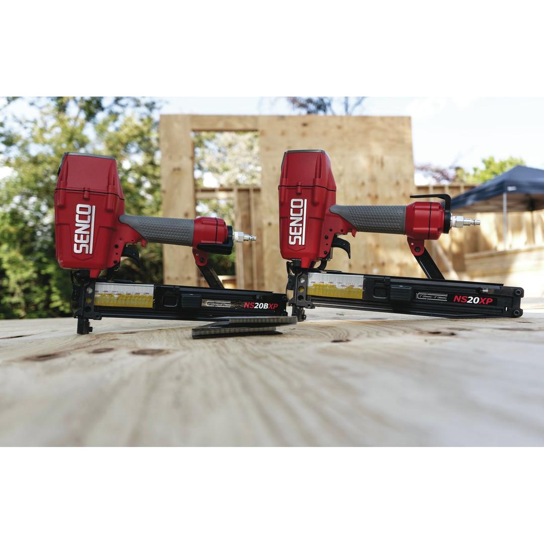 Agrafeuse pneumatique NS20BXP SENCO — Agrafeuses SENCO NS20BXP 25-50 mm posées sur un panneau bois avec raccords d'air bleus en extérieur