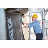 Marteau agrafeur manuel Marteau agrafeur J-044 NOVUS — NOVUS marteau agrafeur J-044 — agrafage d'une membrane DELTA sur façade bois, vu depuis l'échafaudage